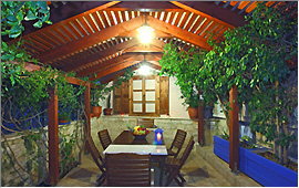 Garden pergola and dining table at night